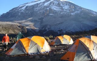 Tents on Mt. Kilimanjaro Uhuru Peak in the background