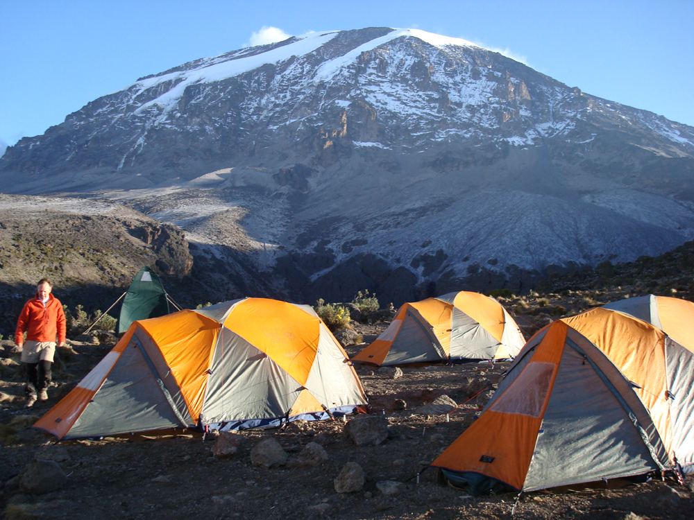 Tents on Mt. Kilimanjaro Uhuru Peak in the background