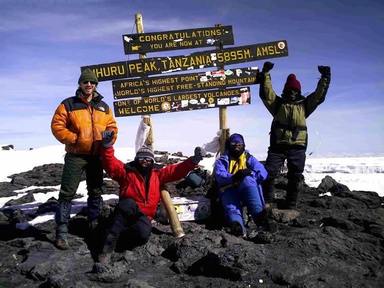 Climber and Porters at Uhuru Peak