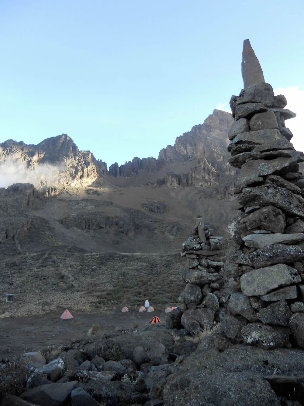 Rock cairns above Mawenzi Tarn Camp with Mawenzi towering behind